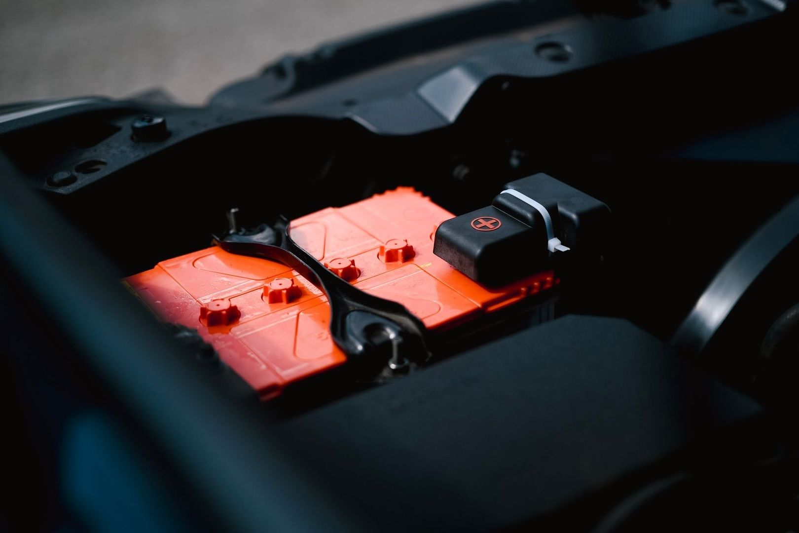 Orangefarbene Bordbatterie mit schwarzer Halterung im Fahrzeug